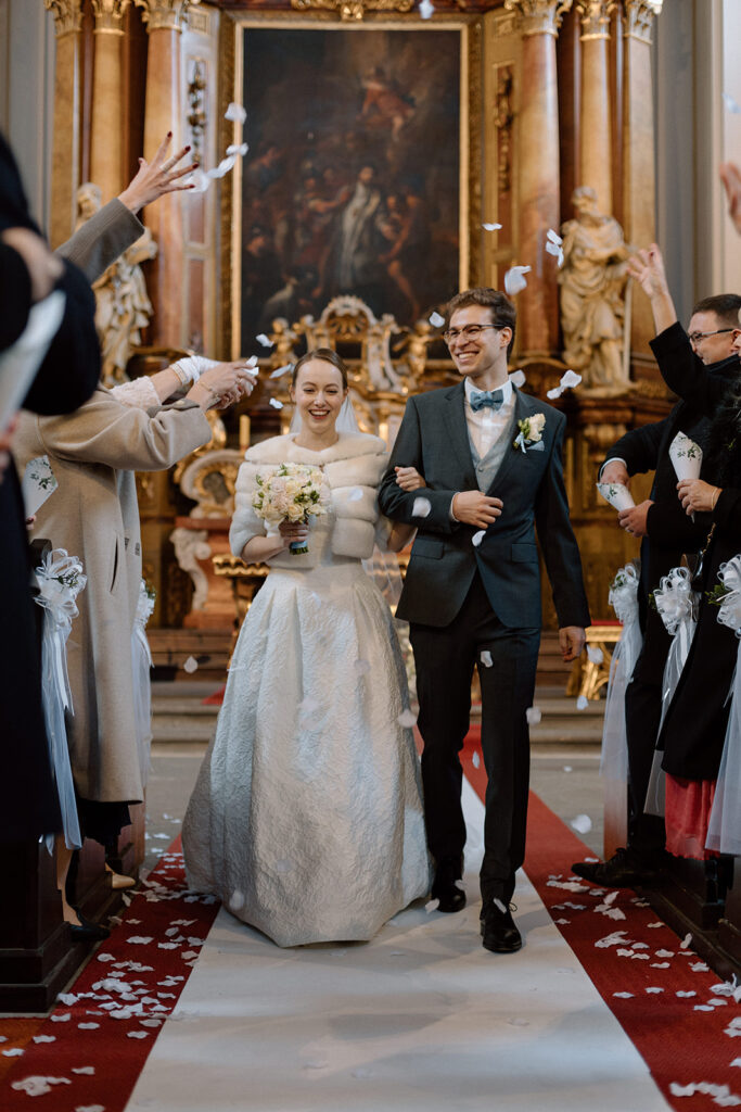 Bride and groom after their wedding ceremony in a church near Prague Castle