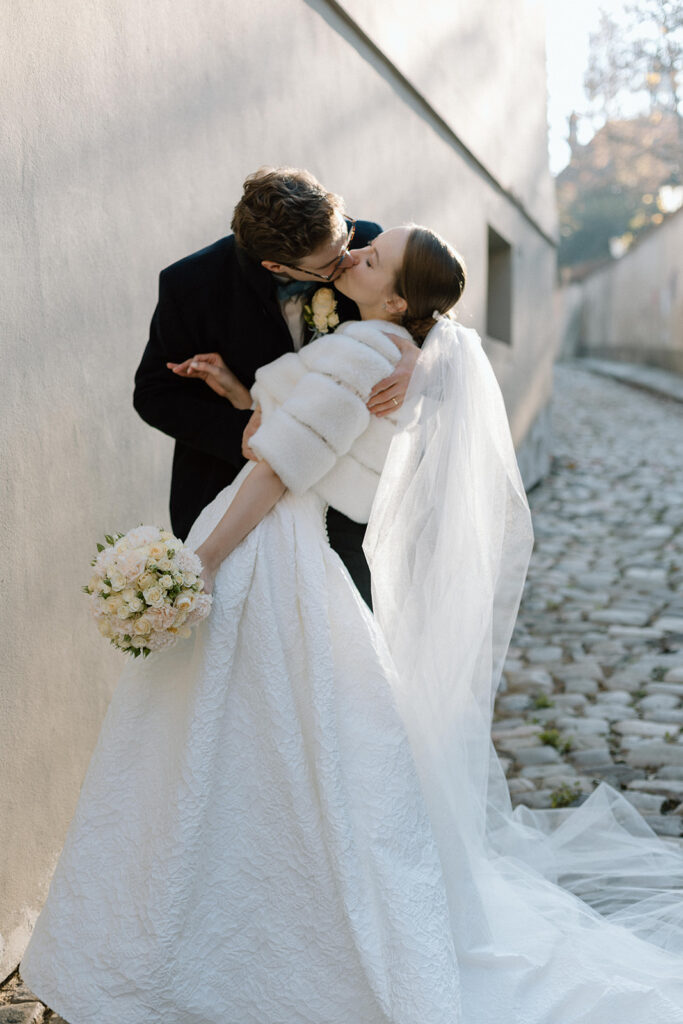 Bride and groom walking through the streets of Nový Svět, a hidden gem in Prague, after their church ceremony in Old Town.
