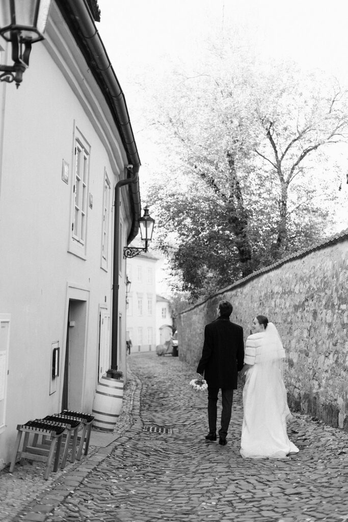 Bride and groom after their wedding ceremony in a church near Prague Castle