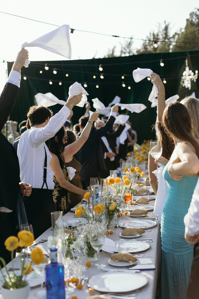 Traditional Basque wedding celebration with guests cheering and waving white napkins