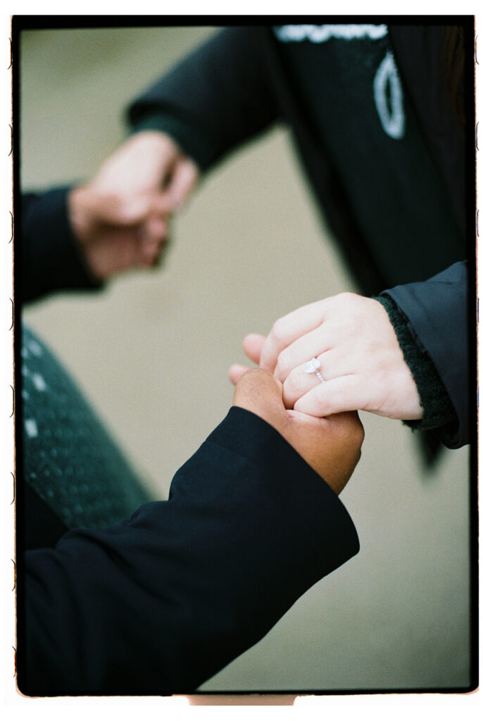 engagement ring and holding hands after the proposal captured on film by Lucie muse