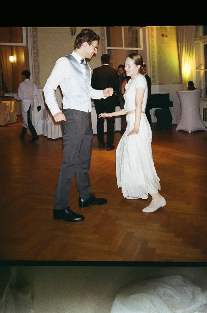 Bride’s dress flowing as she dances with the groom, photographed by a wedding photographer in Prague