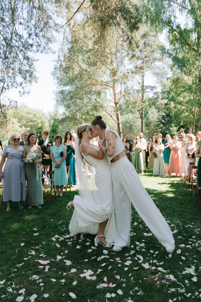 Emotional first kiss at a lesbian wedding ceremony – Artistic wedding photographer Europe – Joyful LGBTQ+ destination wedding photography.