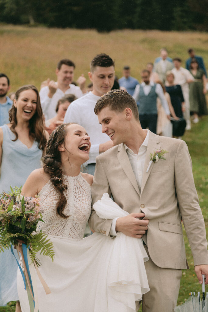 Happy bride crying joyful tears after mountain ceremony – Emotional wedding couple moments in the Alps – Story-based photography by artistic wedding photographer Europe.
