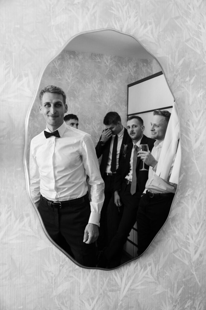 Stylish groom and groomsmen portrait – Artistic wedding photographer Europe – Modern black tie wedding style and candid brotherhood moments.