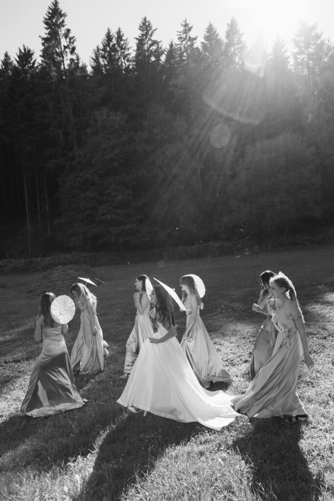 Black and white artsy photo of bride and her bridesmaids captured by Lucie Muse wedding photographer