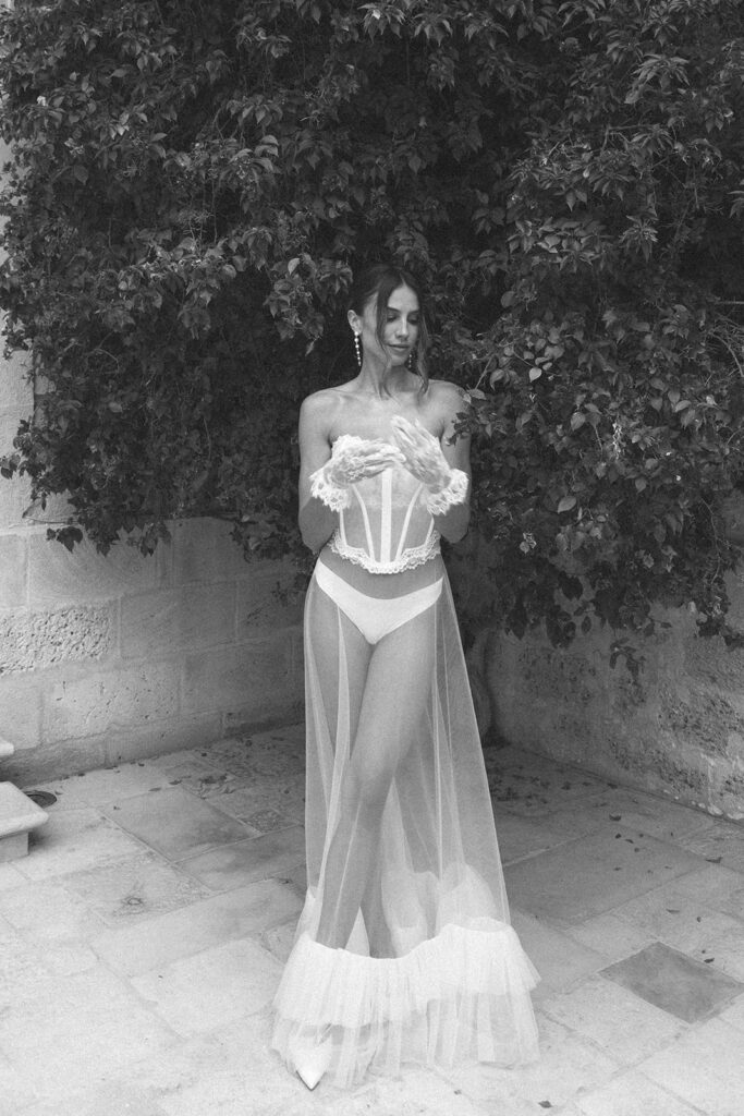 Fashion editorial black and white bridal portrait showcasing intricate corset detail.